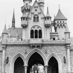 Walt Disney walking through Sleep Beauty Castle